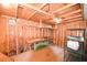 Unfinished basement with exposed wood beams, workbench, and shelving for storage at 1372 Palmetto St, Clearwater, FL 33755