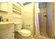 Clean bathroom with toilet, sink, and tiled shower with a shower curtain at 1372 Palmetto St, Clearwater, FL 33755