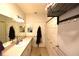Bright bathroom features a long vanity with lots of storage, a mirror and linen rack at 1372 Palmetto St, Clearwater, FL 33755