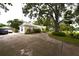 Long driveway leading to a home with mature trees at 1372 Palmetto St, Clearwater, FL 33755