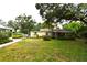 Exterior view of the home and front yard and mature trees at 1372 Palmetto St, Clearwater, FL 33755