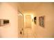 Hallway with white doors and trim, tile floors, and artwork on the walls at 1372 Palmetto St, Clearwater, FL 33755