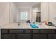 A primary bathroom with a dual sink vanity featuring white countertops and dark cabinetry at 14269 Lemon Yellow Tree Ln, Brooksville, FL 34613