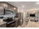 Kitchen featuring stainless steel appliances, dark cabinets, and an open view of the living space at 14269 Lemon Yellow Tree Ln, Brooksville, FL 34613