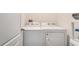 Well-equipped laundry room featuring modern, white, front-loading washer and dryer units at 14269 Lemon Yellow Tree Ln, Brooksville, FL 34613