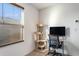 An office space filled with natural light and a cat tree, perfect for working at home at 14269 Lemon Yellow Tree Ln, Brooksville, FL 34613