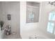 Light and airy bathroom featuring a glass-enclosed shower and separate tub for relaxation at 16331 Burniston Dr, Tampa, FL 33647