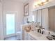 Stylish bathroom featuring a white vanity with modern fixtures, a large mirror, and a shower-tub combination at 16331 Burniston Dr, Tampa, FL 33647