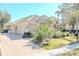 Charming home featuring a tile roof, three-car garage, and lush landscaping at 16331 Burniston Dr, Tampa, FL 33647
