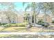 Elegant home exterior showcasing a tile roof, landscaped yard and double doors at 16331 Burniston Dr, Tampa, FL 33647