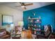 This home office features a wooden desk, comfortable seating, and stylish decor, with a decorative accent wall at 16331 Burniston Dr, Tampa, FL 33647