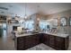 Open kitchen with a large island that provides views into the living area, with custom lighting at 16331 Burniston Dr, Tampa, FL 33647