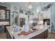 Beautiful kitchen with marble countertops, a central island, and custom plate display cabinet at 16331 Burniston Dr, Tampa, FL 33647