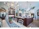 Spacious open-concept kitchen featuring a large island with seating, dining area and custom fixtures at 16331 Burniston Dr, Tampa, FL 33647