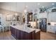 Spacious kitchen featuring a large center island, pendant lighting, and stainless steel appliances at 16331 Burniston Dr, Tampa, FL 33647