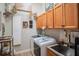 Functional laundry room with ample cabinetry, a utility sink, and modern appliances at 16331 Burniston Dr, Tampa, FL 33647