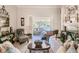 Bright living room with piano, fireplace, and built-in shelving at 16331 Burniston Dr, Tampa, FL 33647