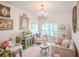 Elegant living room with chandelier lighting, white walls, decorative furniture, and light pink accents at 16331 Burniston Dr, Tampa, FL 33647