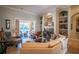 Comfortable living room with fireplace, built-in shelves, and easy access to the lanai at 16331 Burniston Dr, Tampa, FL 33647