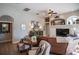 Comfortable living room with a large sectional sofa, decorative furnishings, and warm lighting, complete with ceiling fan at 16331 Burniston Dr, Tampa, FL 33647