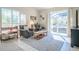 A well-lit living room with comfortable seating and large glass sliding doors leading to the outdoor pool area at 16331 Burniston Dr, Tampa, FL 33647