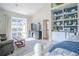This is a bright and airy main bedroom featuring a view of the backyard pool through sliding glass doors at 16331 Burniston Dr, Tampa, FL 33647