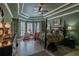 Spacious main bedroom features a tray ceiling, a four-poster bed, and a cozy sitting area by the windows at 16331 Burniston Dr, Tampa, FL 33647