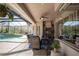 Outdoor living space featuring covered seating, kitchen appliances, and a stunning view of the backyard pool at 16331 Burniston Dr, Tampa, FL 33647