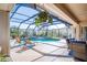 Covered pool area featuring comfortable seating, chairs for lounging, and screened in for outdoor entertainment at 16331 Burniston Dr, Tampa, FL 33647