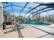 Screened-in pool area with lounge chairs and lush landscaping, perfect for outdoor relaxation and enjoyment at 16331 Burniston Dr, Tampa, FL 33647