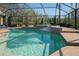 Tranquil pool with cascading steps and a beautiful view of the backyard in a screened-in enclosure at 16331 Burniston Dr, Tampa, FL 33647