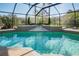 Inviting screened-in pool with a spa and lovely water feature; ideal for relaxation and entertaining outdoors at 16331 Burniston Dr, Tampa, FL 33647