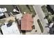 Aerial view of the waterfront home showing the red tile roof, lush landscaping, and boat dock at 17401 1St E St, Redington Shores, FL 33708