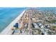 Expansive coastal view of a town with a long stretch of beach, buildings, and a waterway at 19417 Gulf Blvd # D-206, Indian Shores, FL 33785