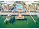 An aerial view of the Barefoot Beach Resort condos, pool, and dock with boat slips and direct Gulf access at 19417 Gulf Blvd # D-206, Indian Shores, FL 33785