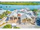 Aerial view of a waterfront building featuring multiple levels, docks, and beautiful water views at 19417 Gulf Blvd # D-206, Indian Shores, FL 33785