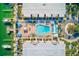 Aerial shot of the Barefoot Beach Resort featuring a large pool with lounge chairs and tropical landscaping at 19417 Gulf Blvd # D-206, Indian Shores, FL 33785