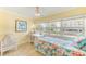 Sunny bedroom offers a bright atmosphere, comfortable bed, and a calming workspace with natural light at 19417 Gulf Blvd # D-206, Indian Shores, FL 33785