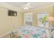 Bright bedroom provides a relaxing retreat with a comfortable bed, tv, and ample natural light at 19417 Gulf Blvd # D-206, Indian Shores, FL 33785