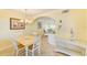 Bright dining room with seating for four flowing into the living room at 19417 Gulf Blvd # D-206, Indian Shores, FL 33785