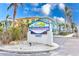 Barefoot Beach Resort signage with tropical landscaping, inviting guests and owners to this waterfront community at 19417 Gulf Blvd # D-206, Indian Shores, FL 33785