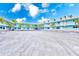 Exterior shot of the resort condos with well-maintained landscaping and ample parking available for owners at 19417 Gulf Blvd # D-206, Indian Shores, FL 33785