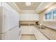 Efficient kitchen features white cabinets, modern appliances, and plenty of counter space at 19417 Gulf Blvd # D-206, Indian Shores, FL 33785