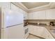Bright kitchen featuring white cabinets, modern appliances, and granite countertops at 19417 Gulf Blvd # D-206, Indian Shores, FL 33785