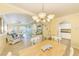 Inviting living room with white wicker furniture that flows into the bright dining area at 19417 Gulf Blvd # D-206, Indian Shores, FL 33785