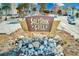 A view of Salt Rock Grill's signage, set amidst decorative rocks and lush greenery at 19417 Gulf Blvd # D-206, Indian Shores, FL 33785