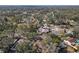 Wide aerial shot shows a neighborhood with homes surrounded by mature trees, and an open landscape at 245 Faithway Dr, Seffner, FL 33584