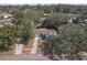 Aerial view of a charming house nestled among mature trees in a quiet residential neighborhood at 245 Faithway Dr, Seffner, FL 33584