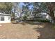 A large backyard with a patio, garden beds, and plenty of space for outdoor activities at 245 Faithway Dr, Seffner, FL 33584