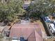 An aerial shot of a backyard with mature trees, an outdoor seating area, and an RV parked behind the fence at 245 Faithway Dr, Seffner, FL 33584